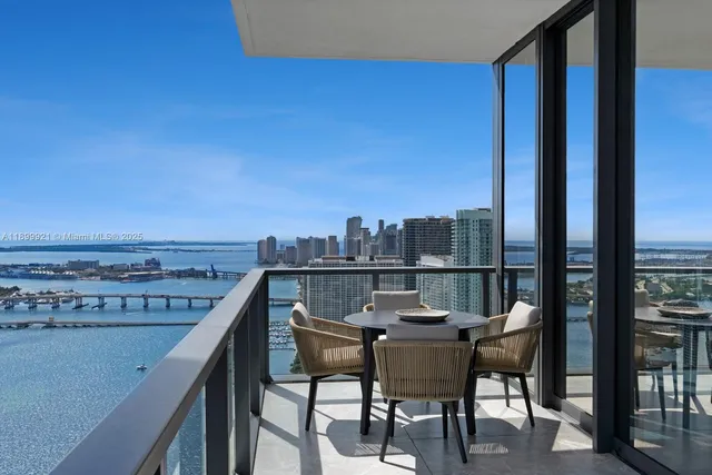 a view of a chairs and table in the balcony