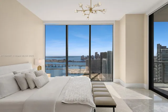 a bedroom with furniture and a large window