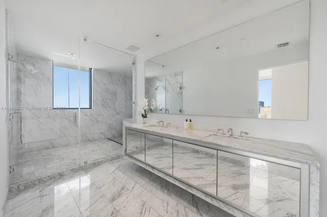 a bathroom with double sink and a mirror