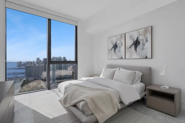 a bedroom with a bed and glass wall painting