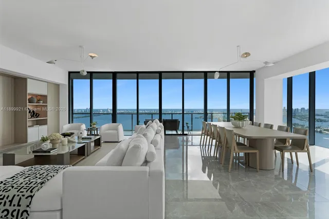 a very nice looking living room with a large window and a table