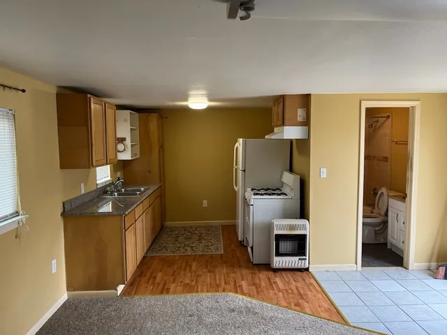 a kitchen with granite countertop a refrigerator and a stove