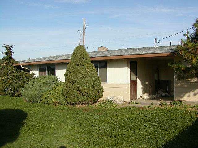 3250 Ashue Road Wapato, WA 98951 - Photo 2 of 9 a front view of a house with a garden