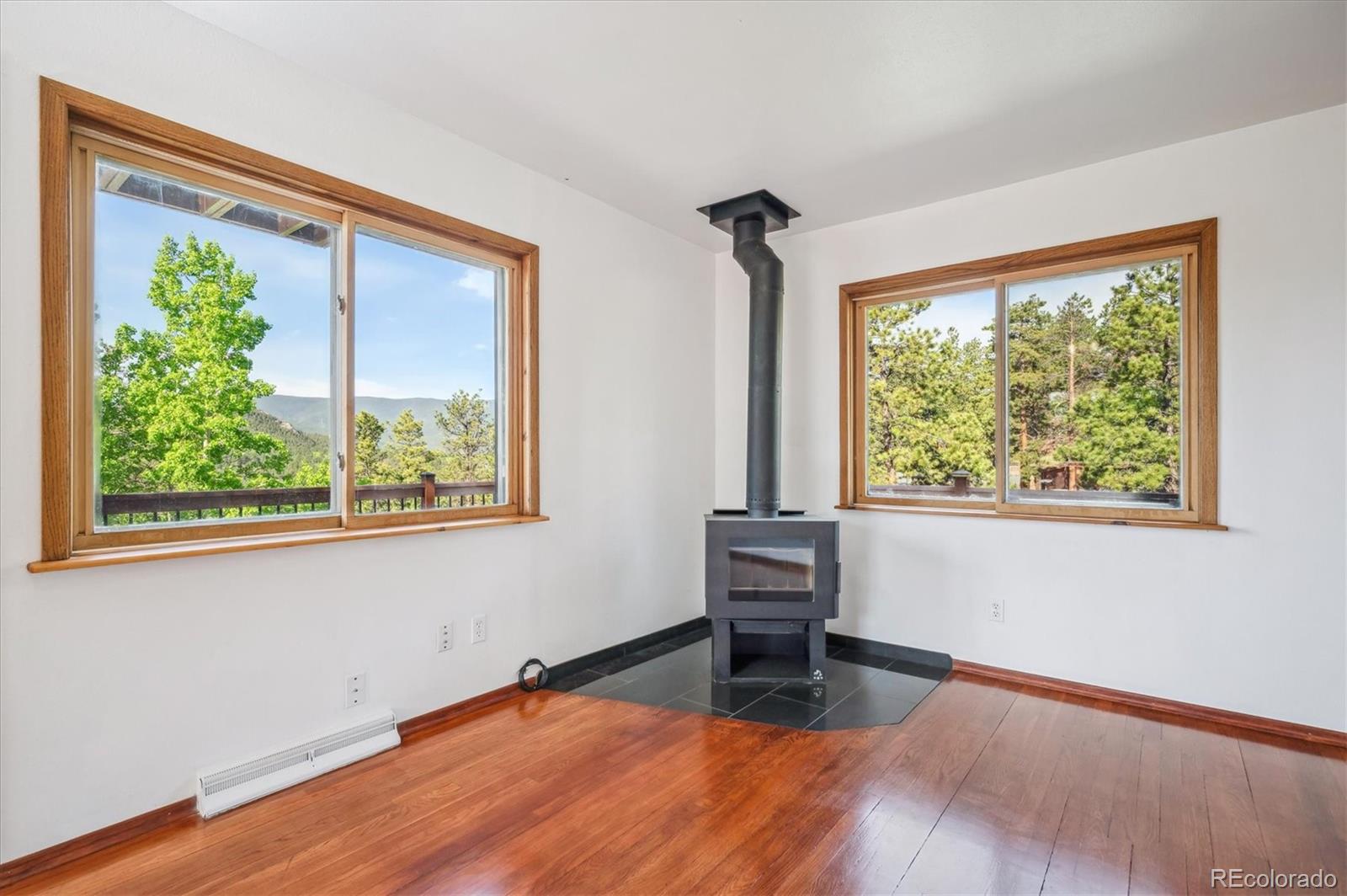 429 Overlook Drive Bailey, CO 80421 - Photo 12 of 36 a view of an empty room with wooden floor and a window