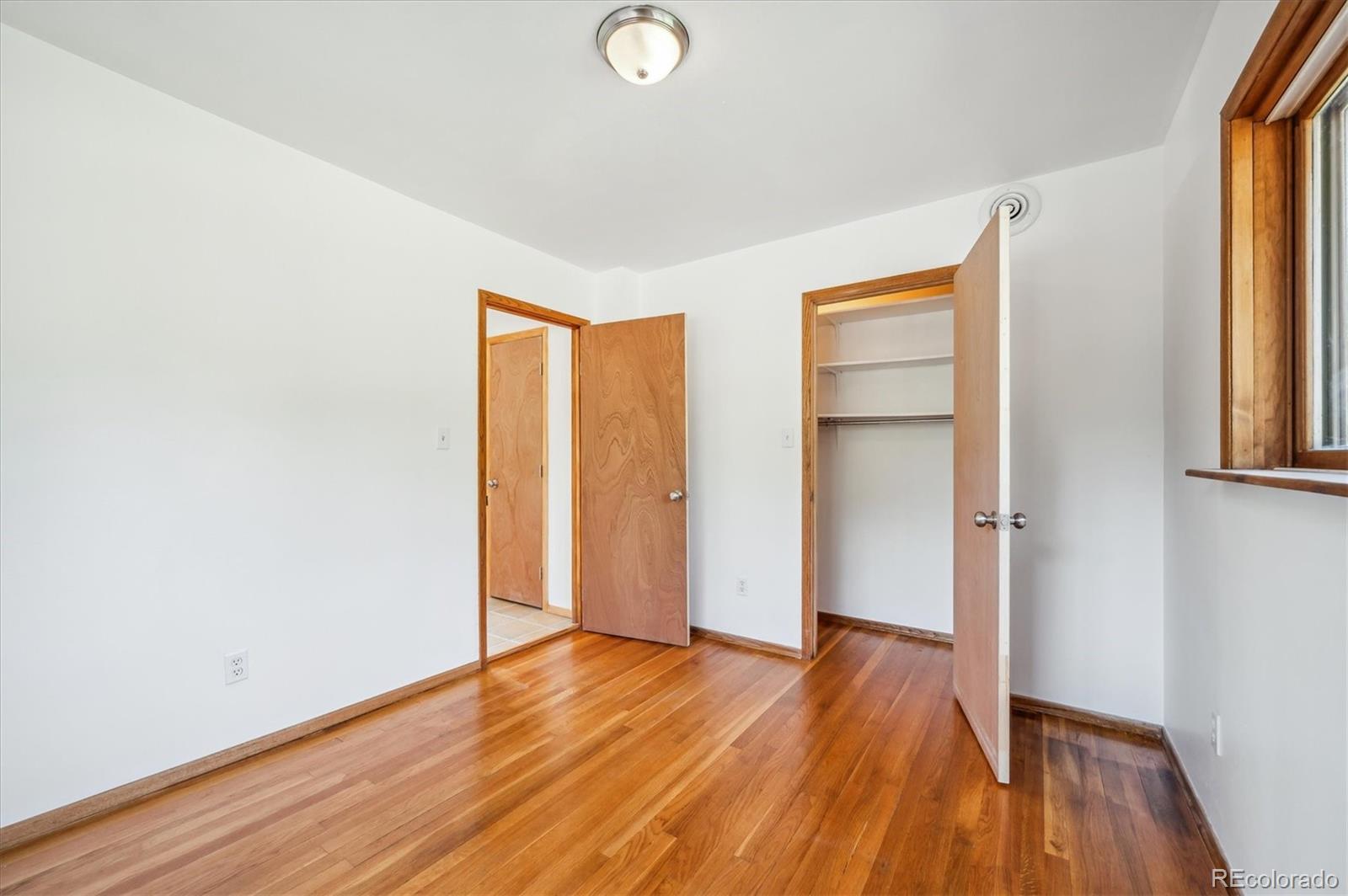 429 Overlook Drive Bailey, CO 80421 - Photo 14 of 36 an empty room with wooden floor and windows