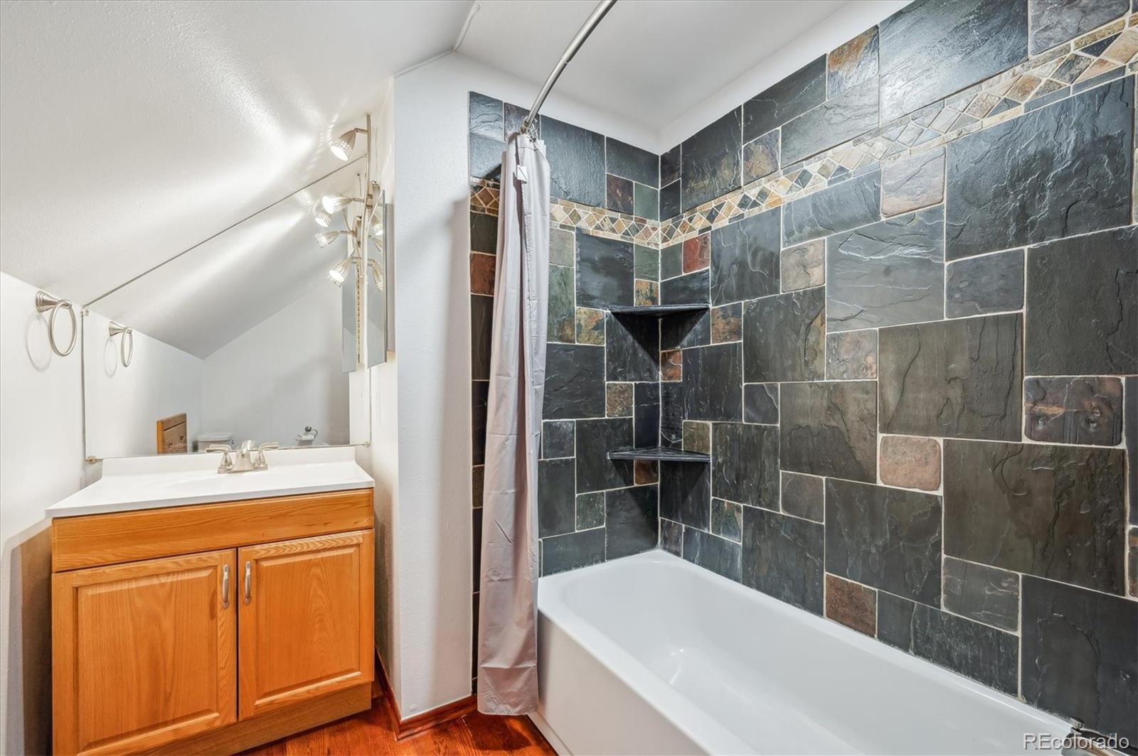 429 Overlook Drive Bailey, CO 80421 - Photo 18 of 36 a bathroom with a sink and mirror with bathtub