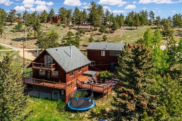 an aerial view of a house with backyard