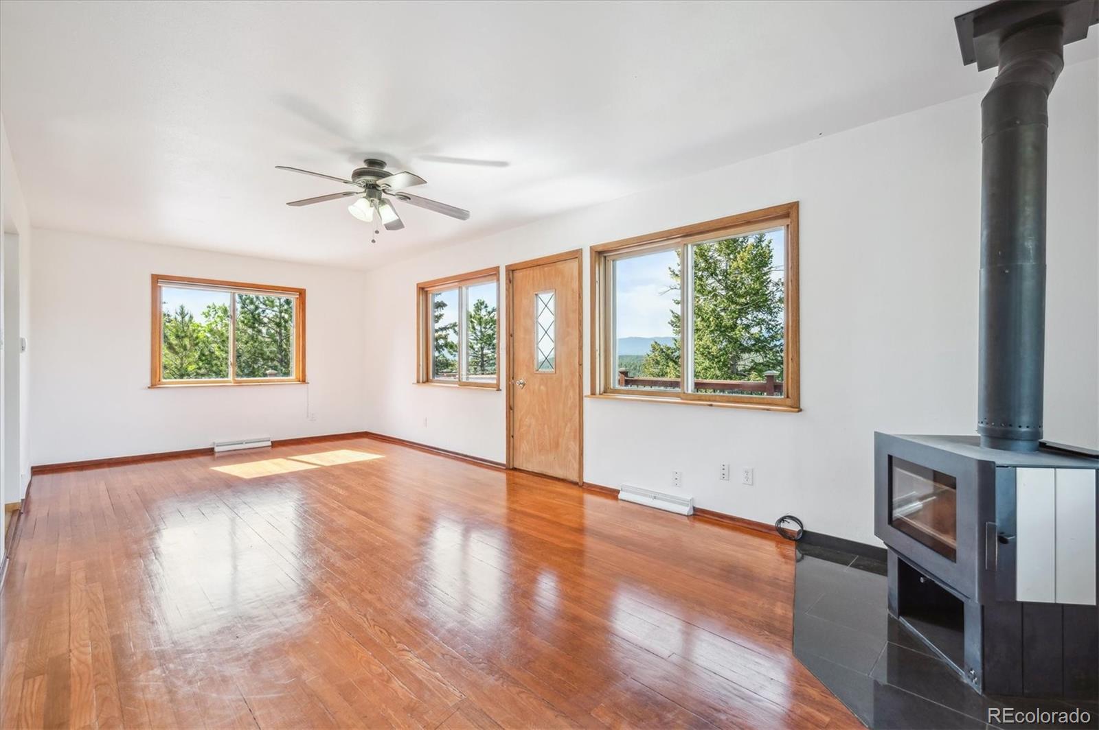 429 Overlook Drive Bailey, CO 80421 - Photo 10 of 36 a view of an empty room with a window and wooden floor