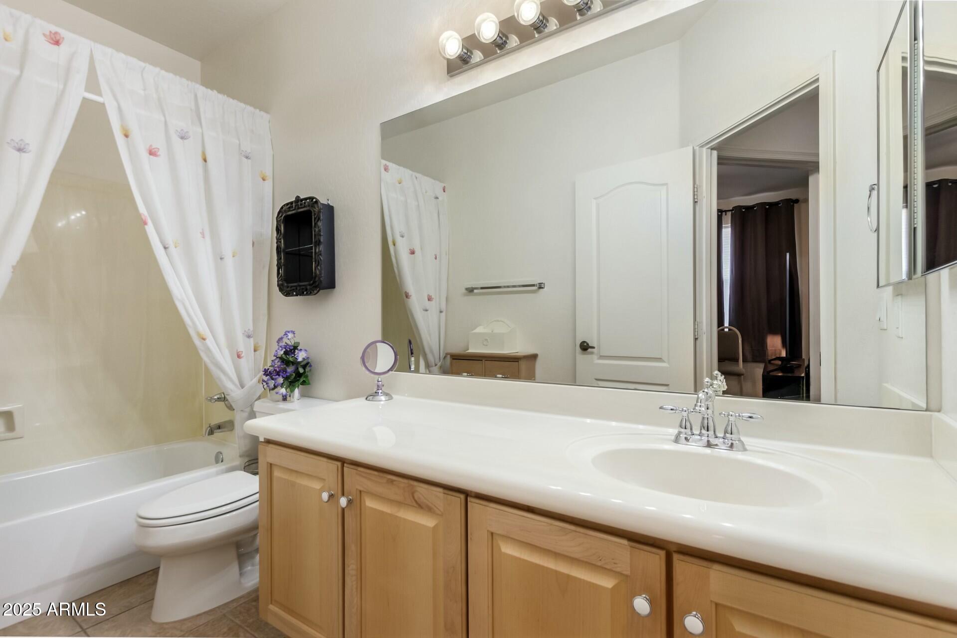 3038 West Trapanotto Road Phoenix, AZ 85086 - Photo 11 of 15 a bathroom with a granite countertop sink toilet and shower