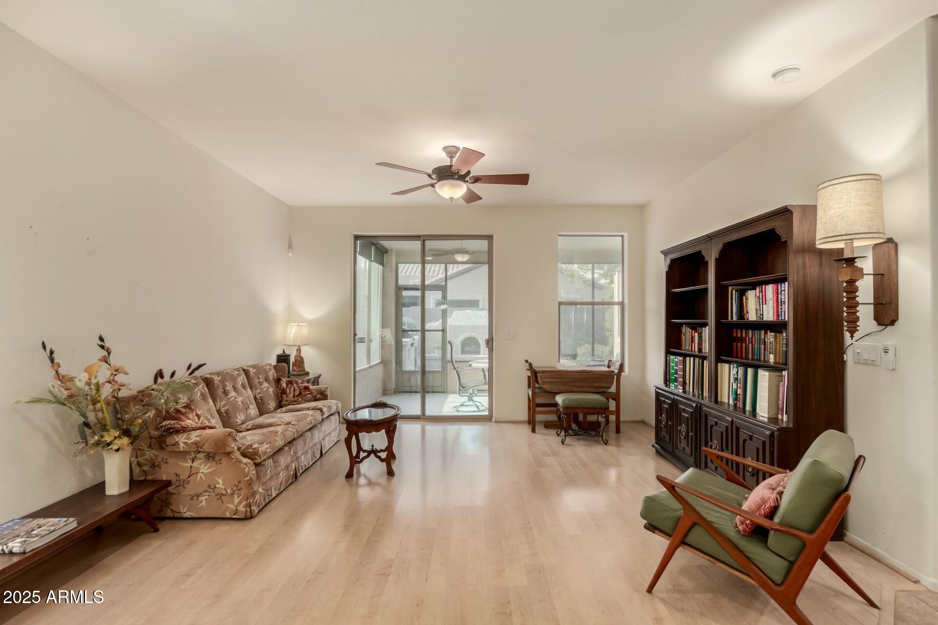 3038 West Trapanotto Road Phoenix, AZ 85086 - Photo 6 of 15 a living room with furniture and a large window with wooden floor