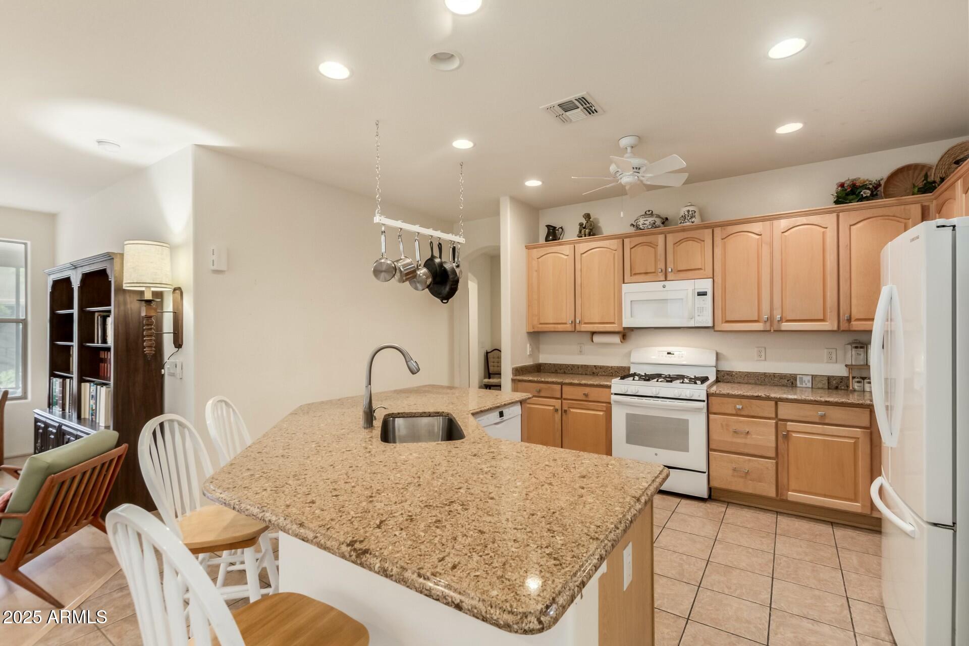 3038 West Trapanotto Road Phoenix, AZ 85086 - Photo 7 of 15 a kitchen with granite countertop a sink stainless steel appliances and cabinets