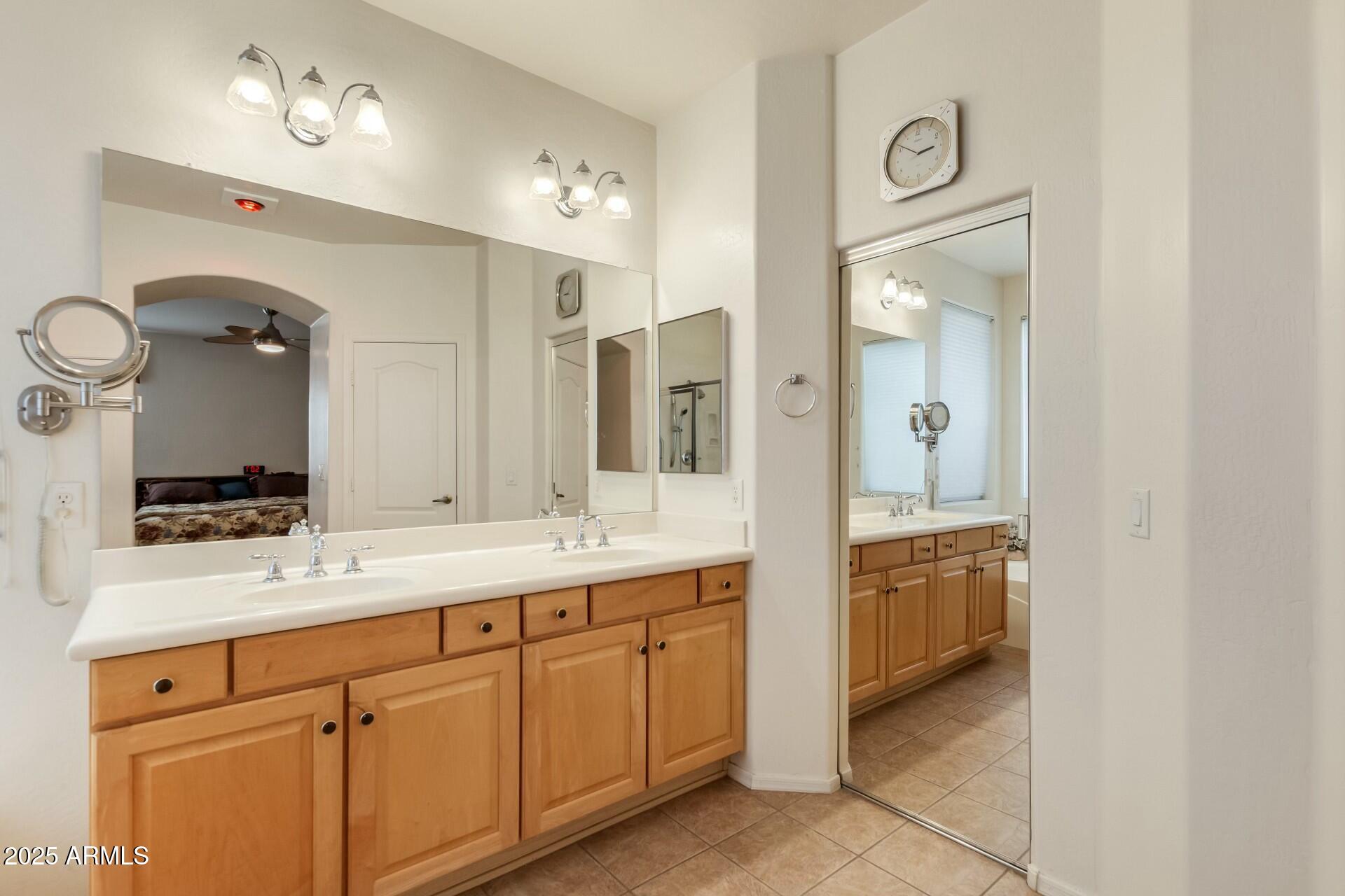 3038 West Trapanotto Road Phoenix, AZ 85086 - Photo 8 of 15 a bathroom with a double vanity sink and mirror with shower