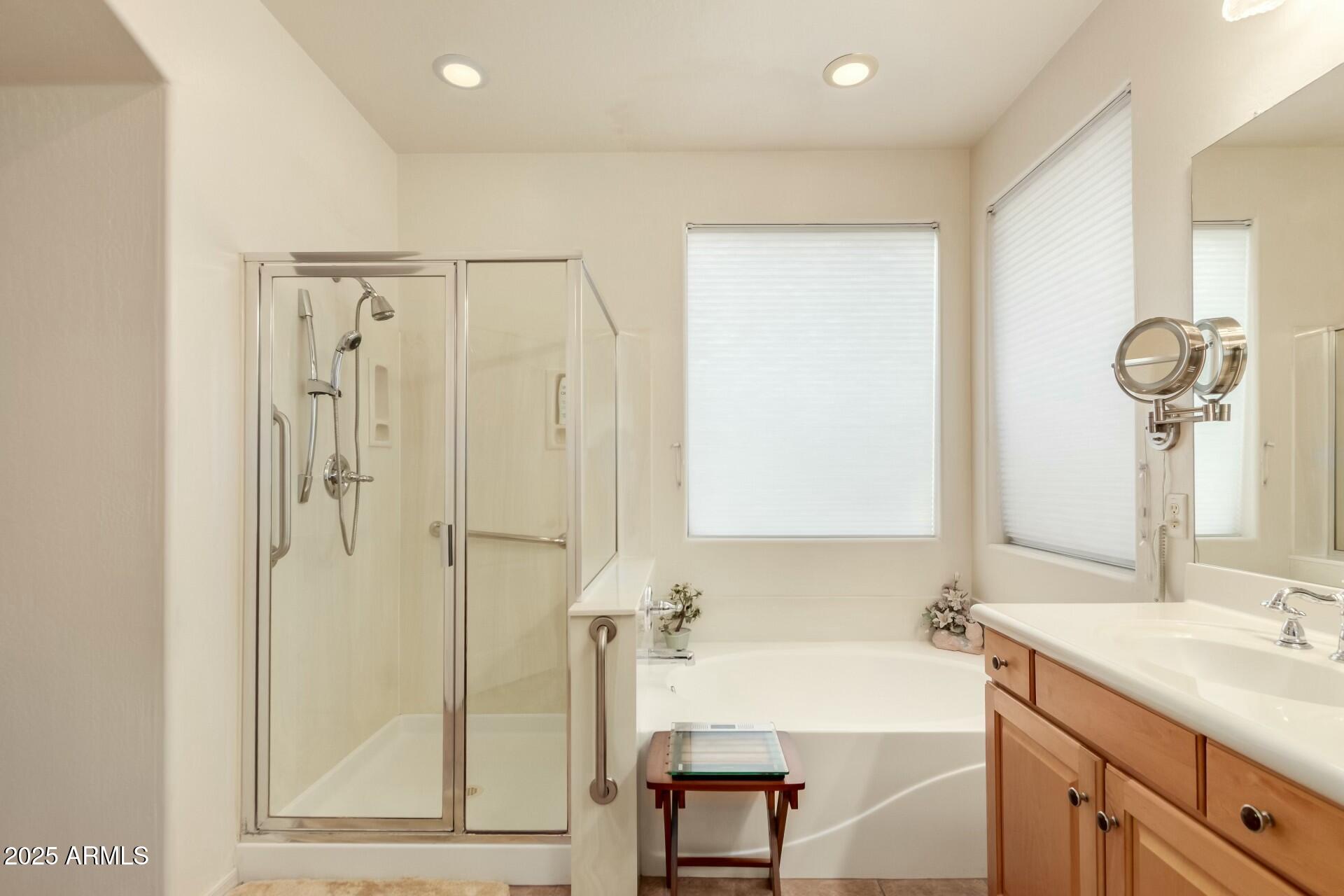 3038 West Trapanotto Road Phoenix, AZ 85086 - Photo 9 of 15 a bathroom with a tub sink and mirror