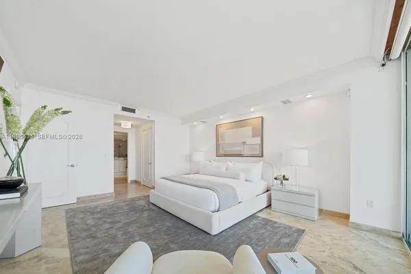 a bedroom with a bed couch and a potted plant