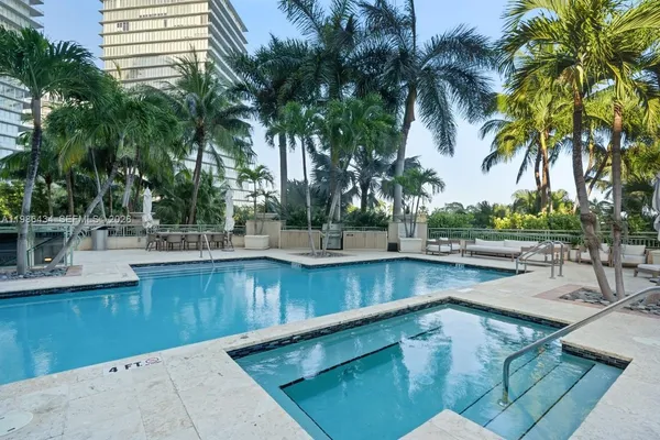 a view of a swimming pool with a table and chairs