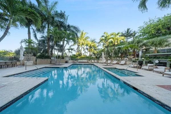 a view of swimming pool with sitting area