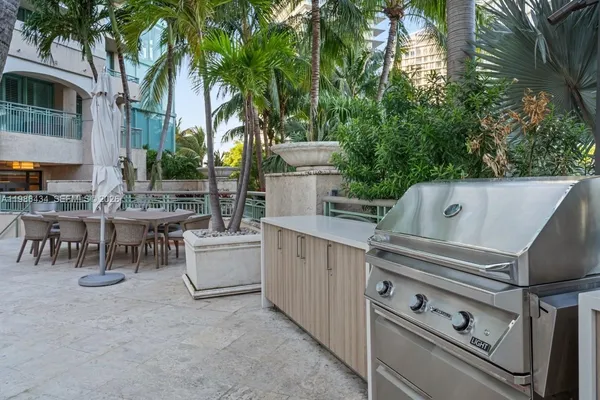 a view of a chairs and table in the back yard