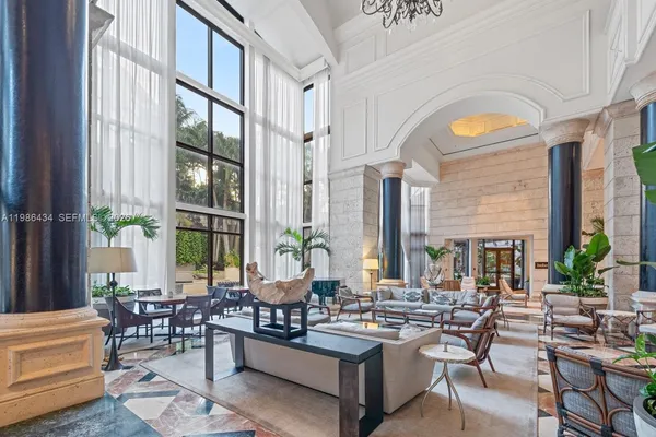 a living room with fireplace furniture and a large window