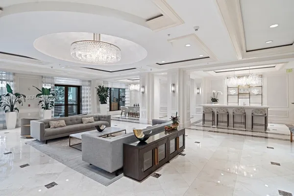 a living room with furniture and a chandelier