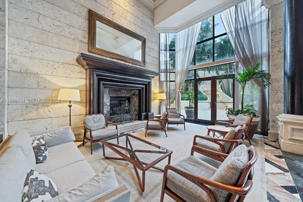 a living room with furniture a large window and a fireplace