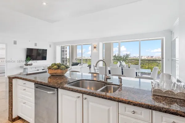 a kitchen with sink a window and cabinets