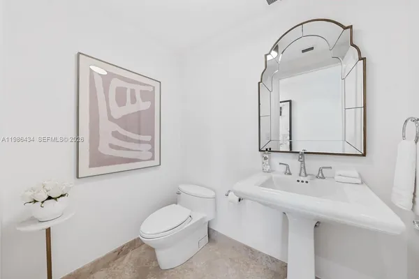 a bathroom with a toilet sink and mirror