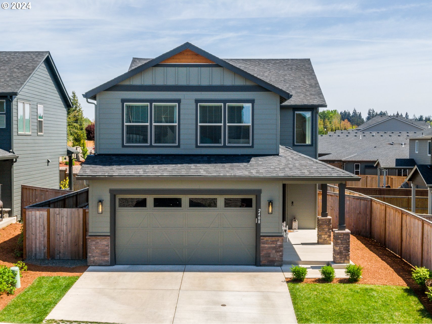 2408 South Eagle Ridge Drive Ridgefield, WA 98642 - Photo 1 of 32 a front view of a house with a yard
