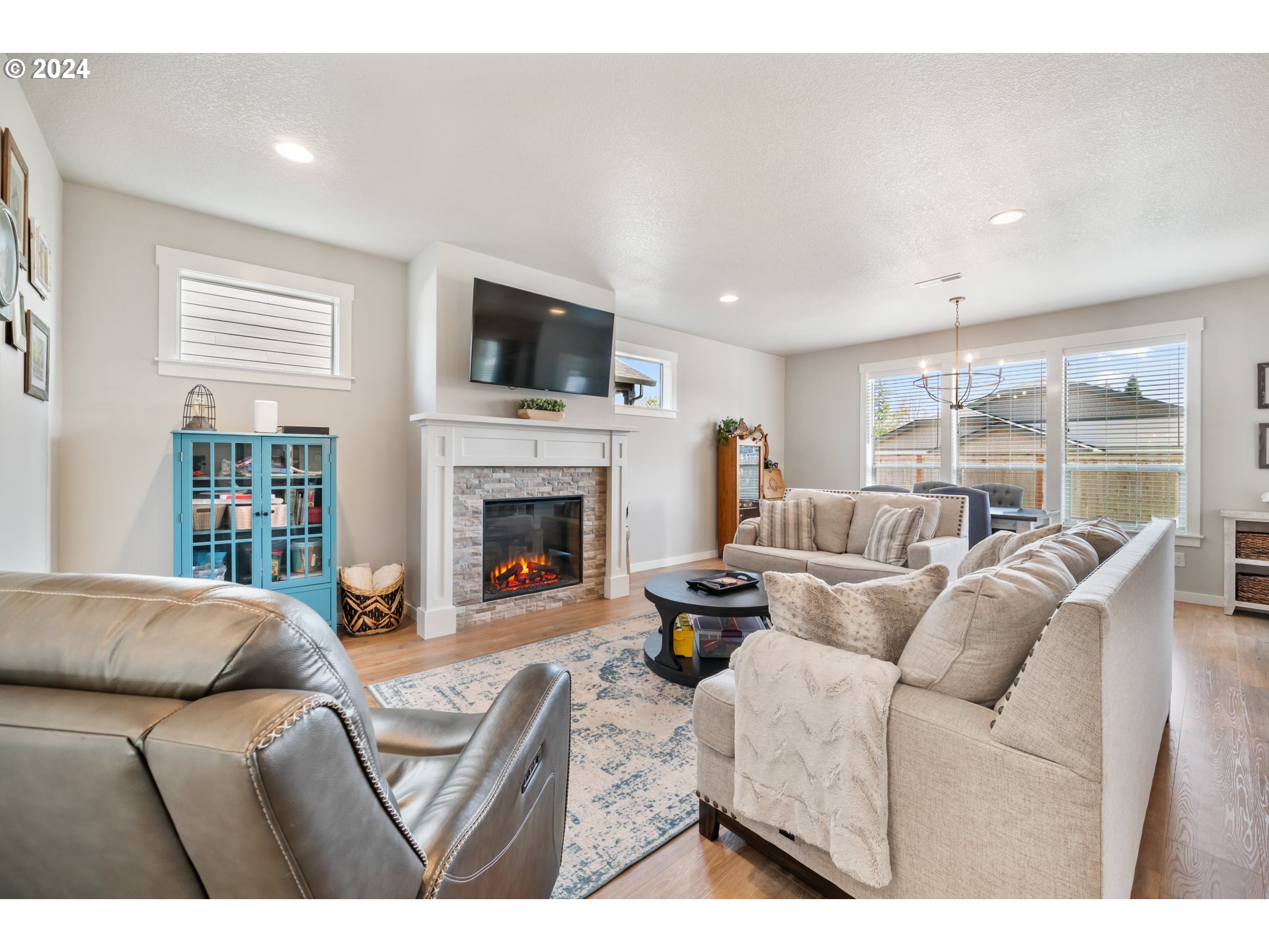 2408 South Eagle Ridge Drive Ridgefield, WA 98642 - Photo 7 of 32 a living room with furniture a flat screen tv and a fireplace