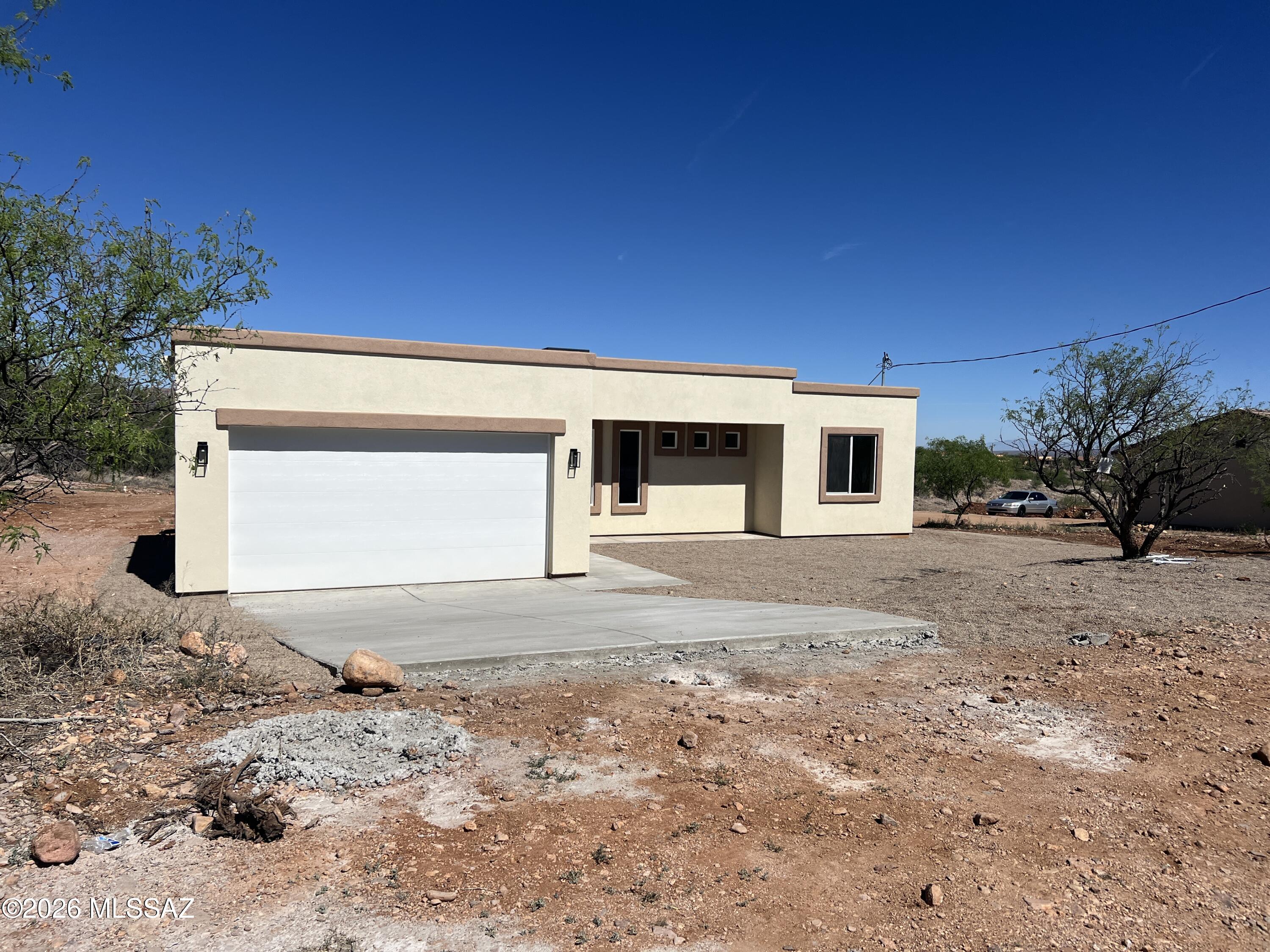 1501 Circulo Sombrero Rio Rico, AZ 85648 - Photo 3 of 26 a front view of a house with a yard and garage