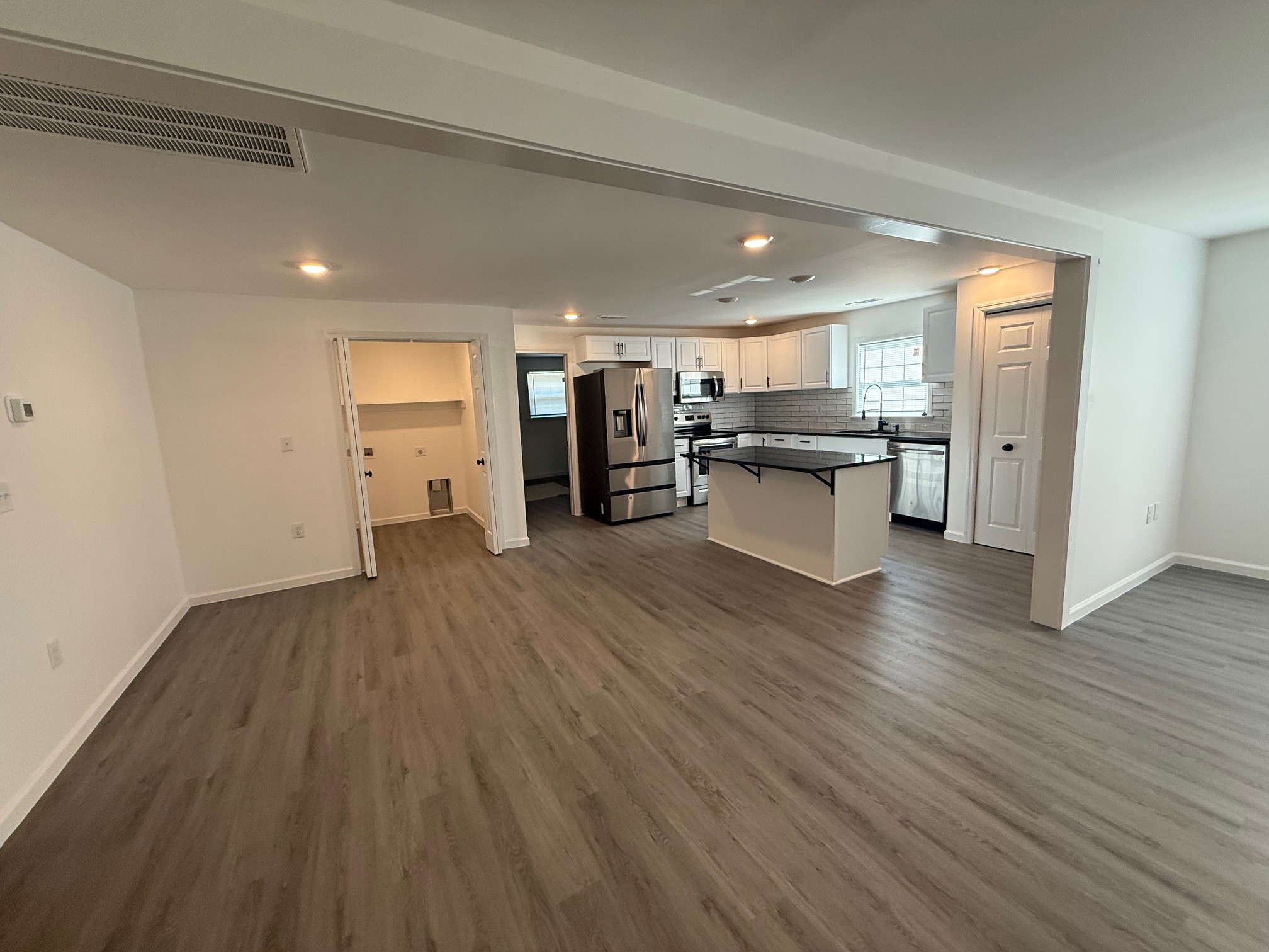 140 Phillips Street Pulaski, TN 38478 - Photo 13 of 32 a kitchen with a wooden floor and a refrigerator