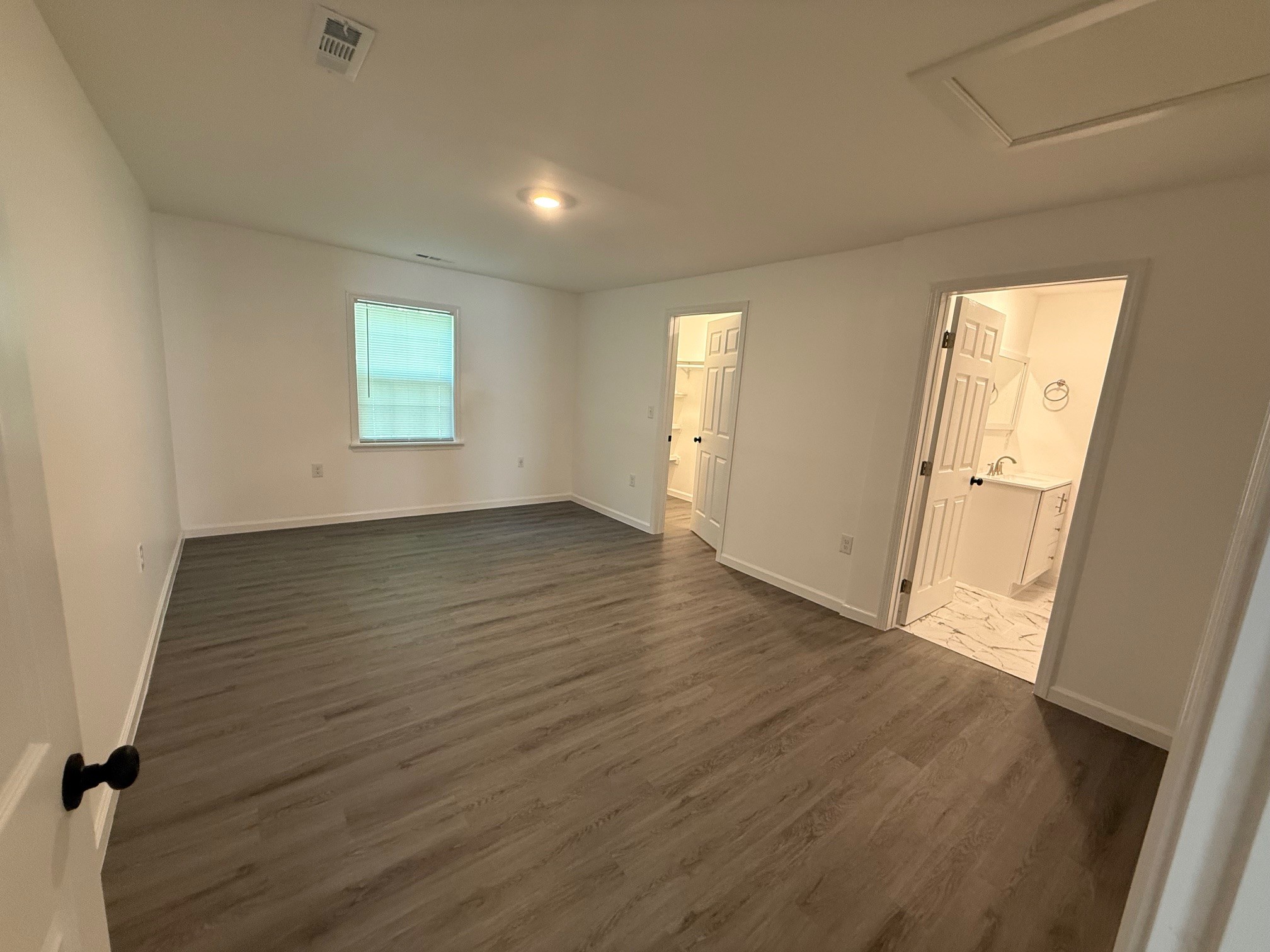 140 Phillips Street Pulaski, TN 38478 - Photo 17 of 32 an empty room with wooden floor and windows