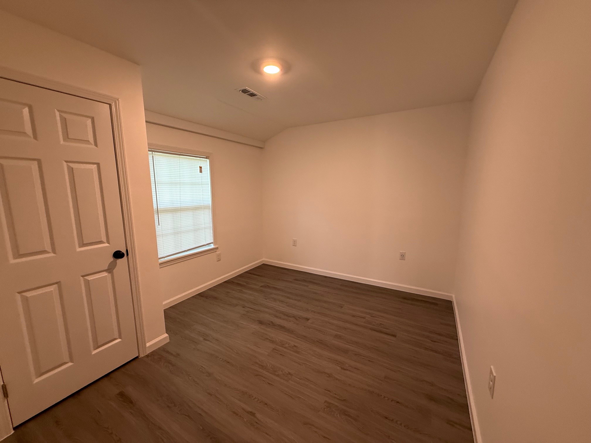 140 Phillips Street Pulaski, TN 38478 - Photo 20 of 32 an empty room with wooden floor and windows