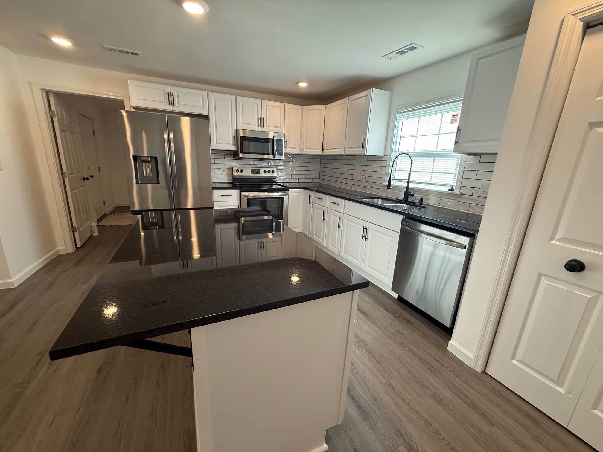 140 Phillips Street Pulaski, TN 38478 - Photo 8 of 32 a kitchen with stainless steel appliances a refrigerator a sink a stove a microwave and island