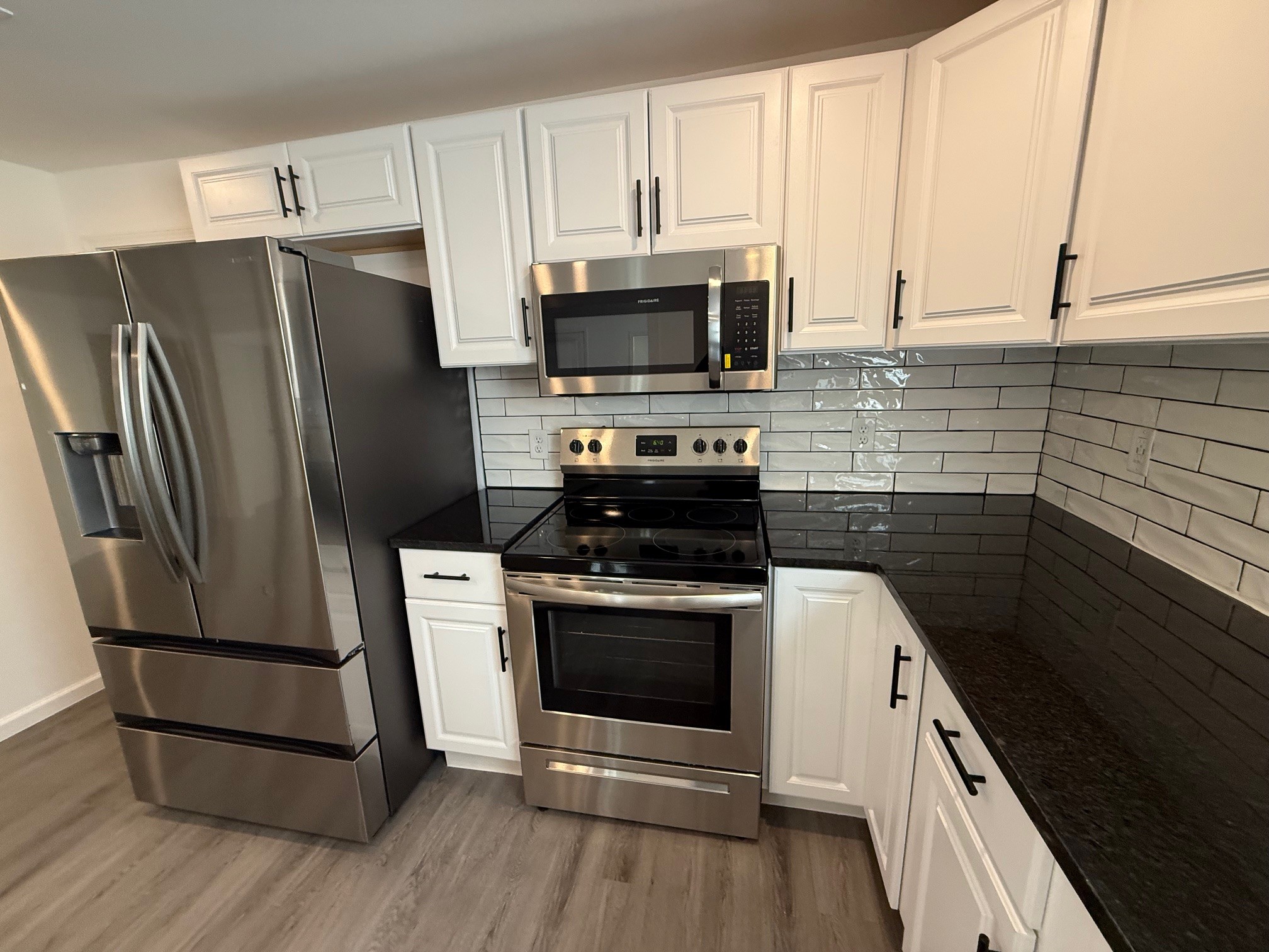 140 Phillips Street Pulaski, TN 38478 - Photo 10 of 32 a kitchen with stainless steel appliances a stove a microwave and a refrigerator