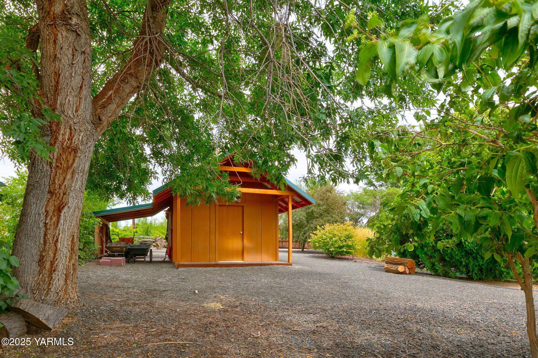 720 Ghormley Road Yakima, WA 98908 - Photo 17 of 47 a view of a house with large tree and wooden fence