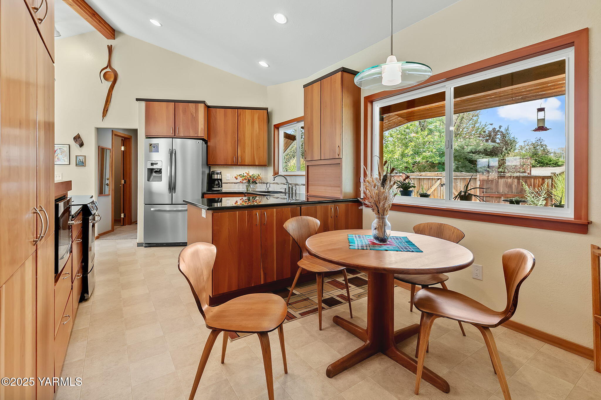 720 Ghormley Road Yakima, WA 98908 - Photo 28 of 47 a dining room with stainless steel appliances granite countertop a table chairs and a refrigerator