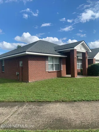 a front view of a house with a garden