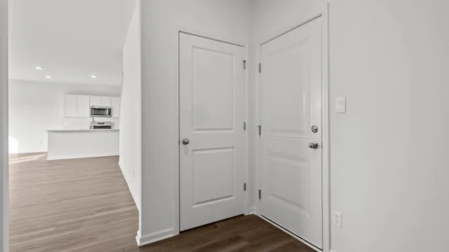 a view of a hallway with wooden floor