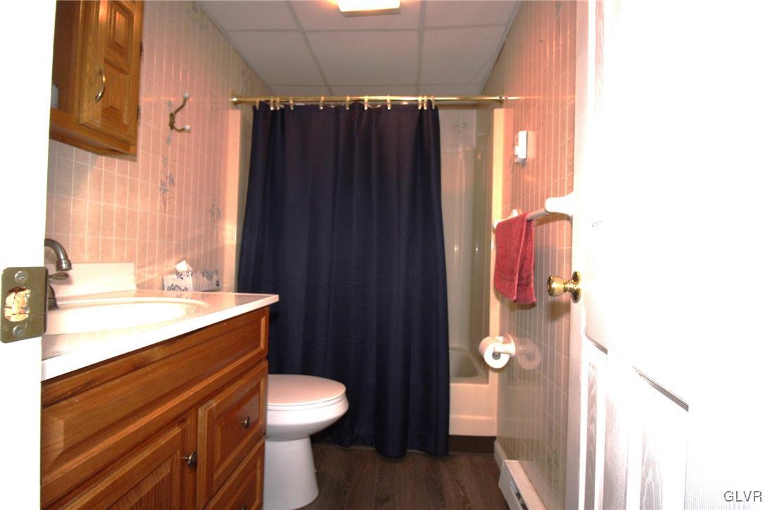 18 Valley View Drive Bath, PA 18014 - Photo 24 of 30 a bathroom with a sink a toilet a mirror and shower curtain