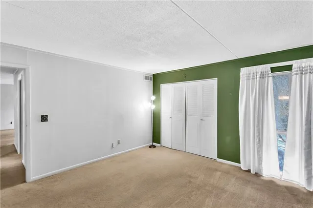 a view of an empty room with a fireplace