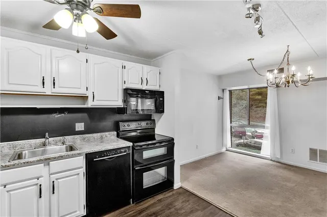 a kitchen with stainless steel appliances granite countertop a sink and cabinets