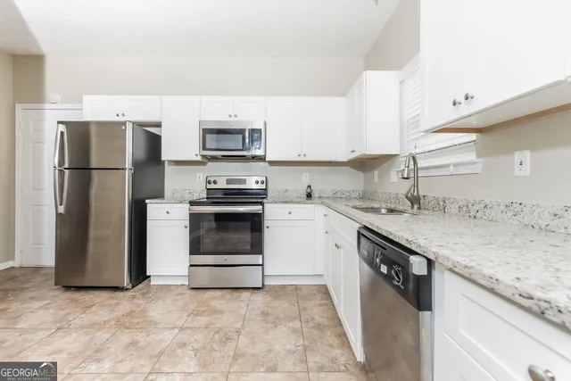a kitchen with a sink stove and refrigerator