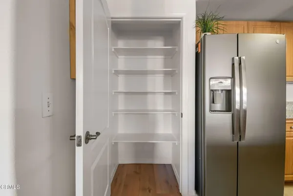 a kitchen with granite countertop a sink stainless steel appliances a window and dining table