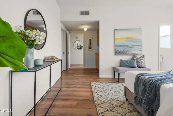 a bedroom with a bed and wooden floor