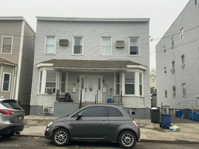 a front view of a house with parking space