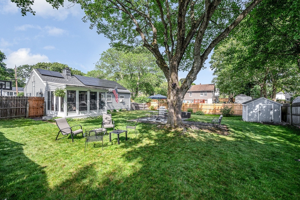 a backyard of a house with table and chairs