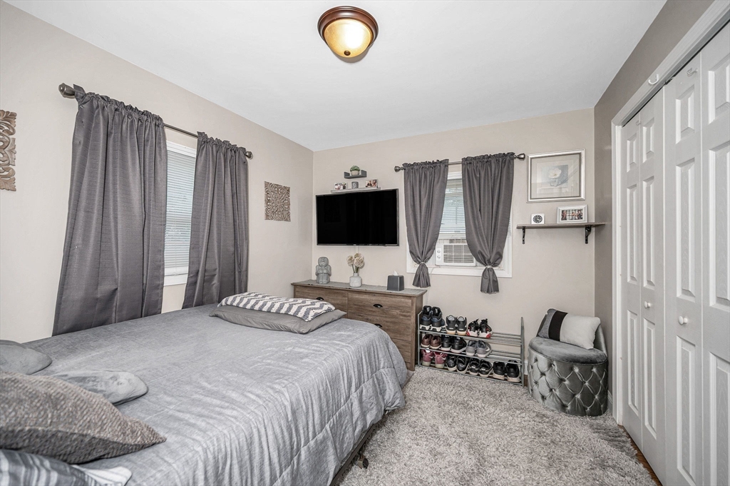 63 Jasper Street Saugus, MA 01906 - Photo 11 of 22 a bedroom with a bed and flat screen tv