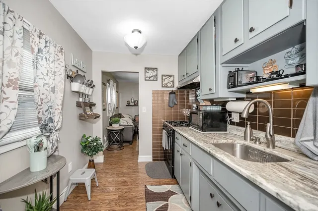 a kitchen with stainless steel appliances granite countertop a sink and a refrigerator