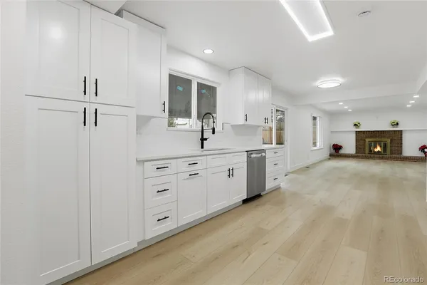 a large white kitchen with stainless steel appliances
