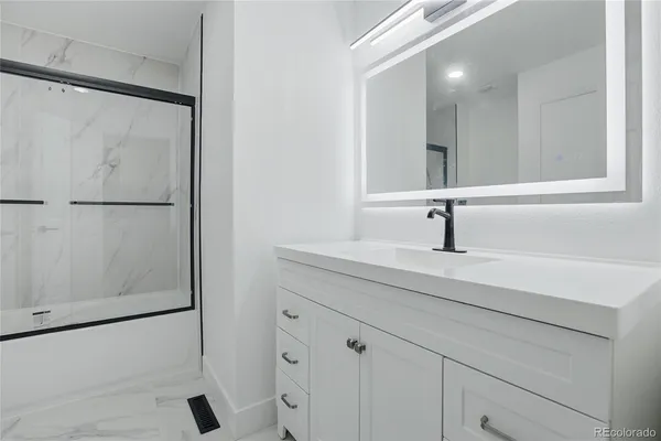 a bathroom with a sink and mirror